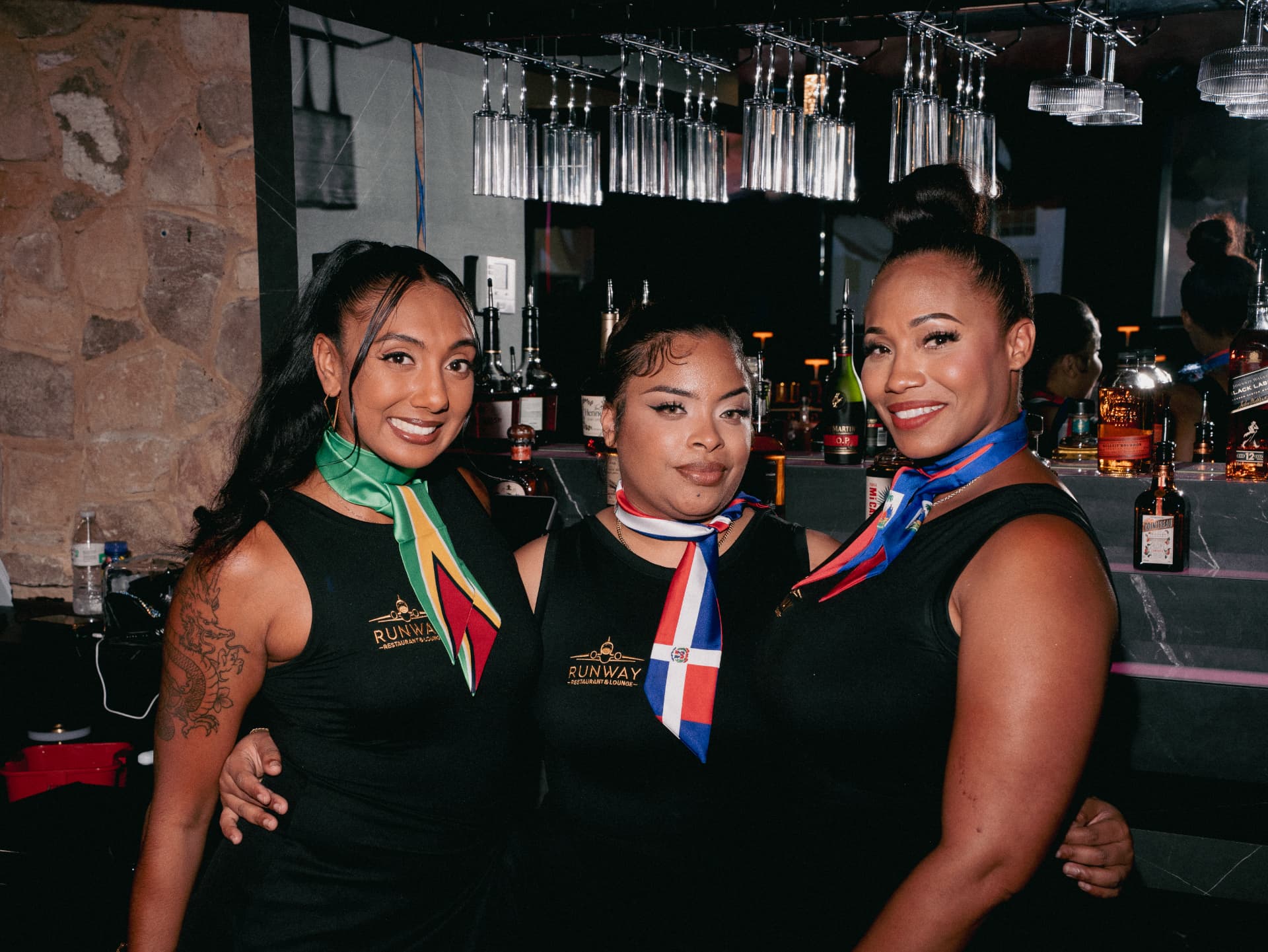 The Runway crew behind the bar in their nations' colors